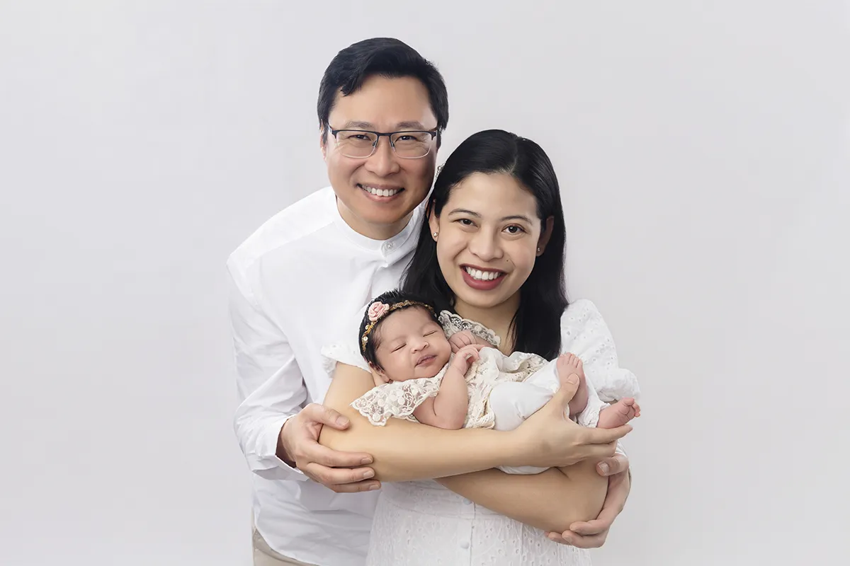 Parents holding their newborn baby during family newborn photography session